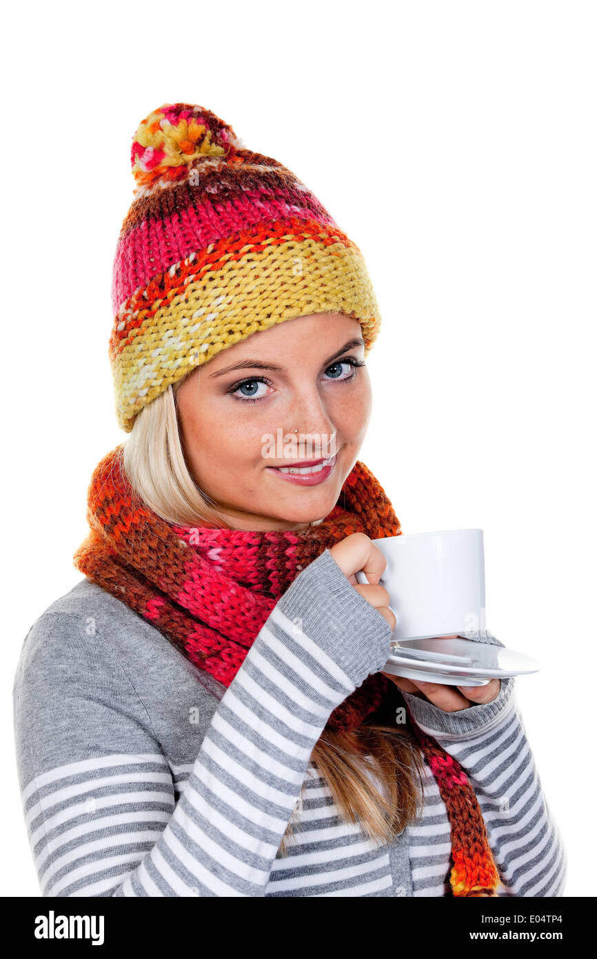 Young woman with voucher net warms herself with hot tea., Junge Frau mit Haube waermt sich mit heissem Tee. Stock Photo