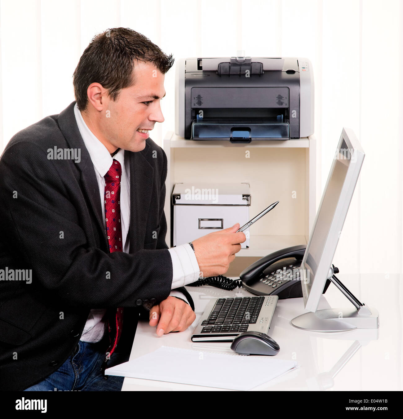 Young businessman in the office with computer, Junger Geschaeftsmann im Buero mit Computer Stock Photo