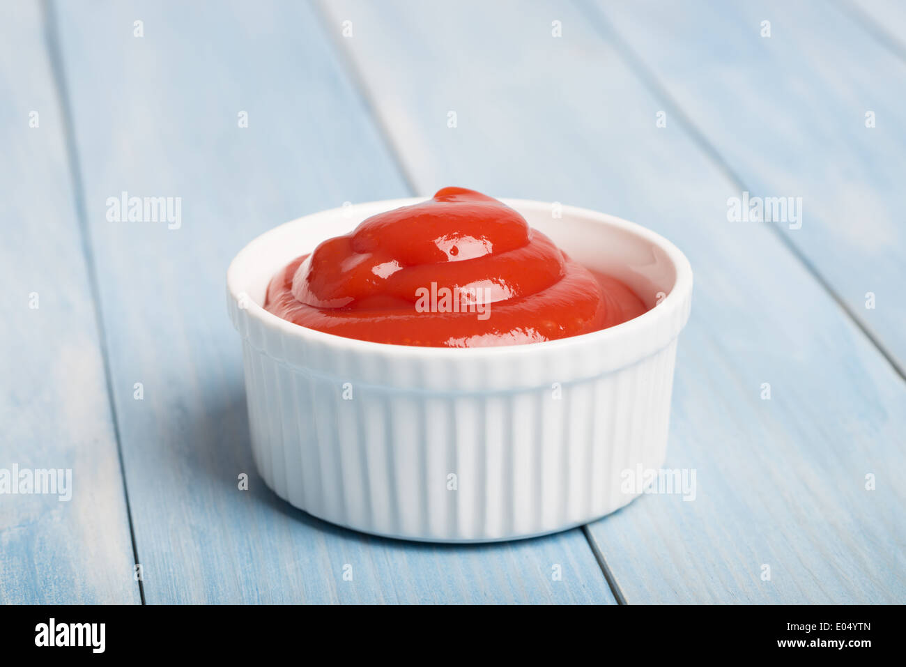 Portion of tomato sauce in a white ceramic dish Stock Photo
