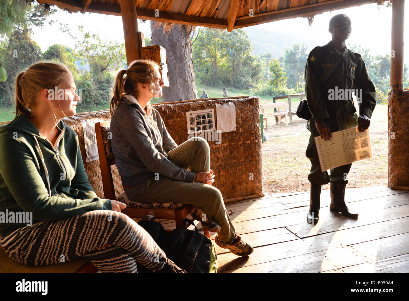 a group of tourists receives information from a ranger before trekking to find gorilla's in bwindi national park, Uganda Stock Photo