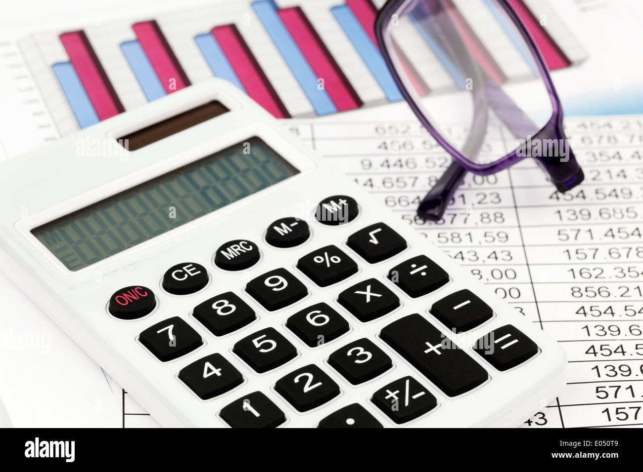 A pocket calculator and different statistics while calculating of balance, turnover and profit., Ein Taschenrechner und verschie Stock Photo