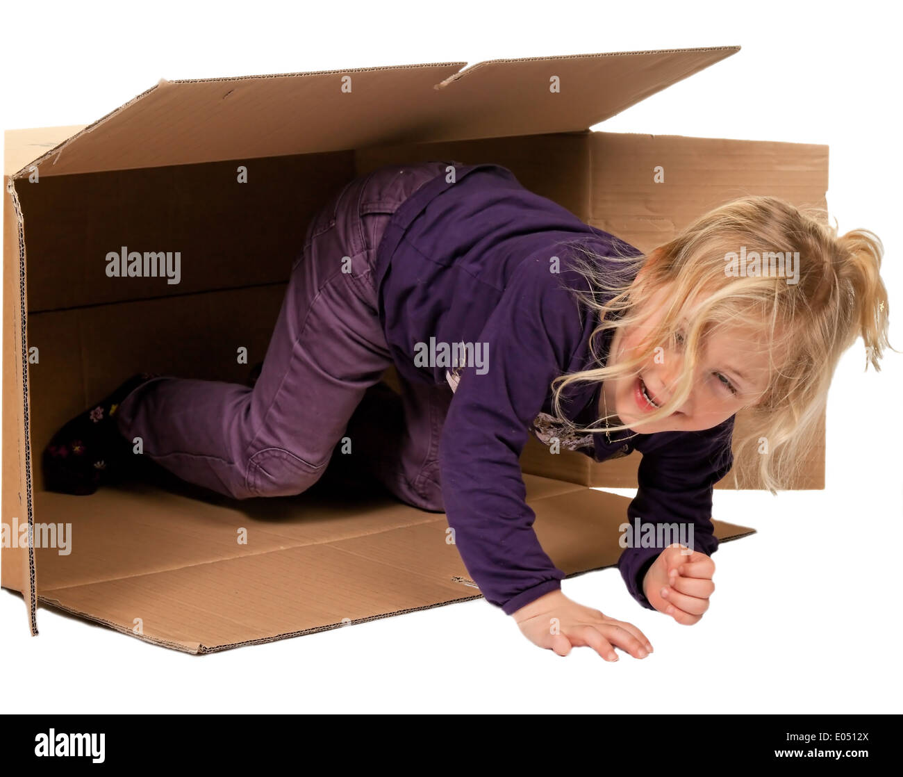 Child in move cardboard. Lies with the move in box., Kind in Umzugskarton. Liegt beim Umzug in Schachtel. Stock Photo