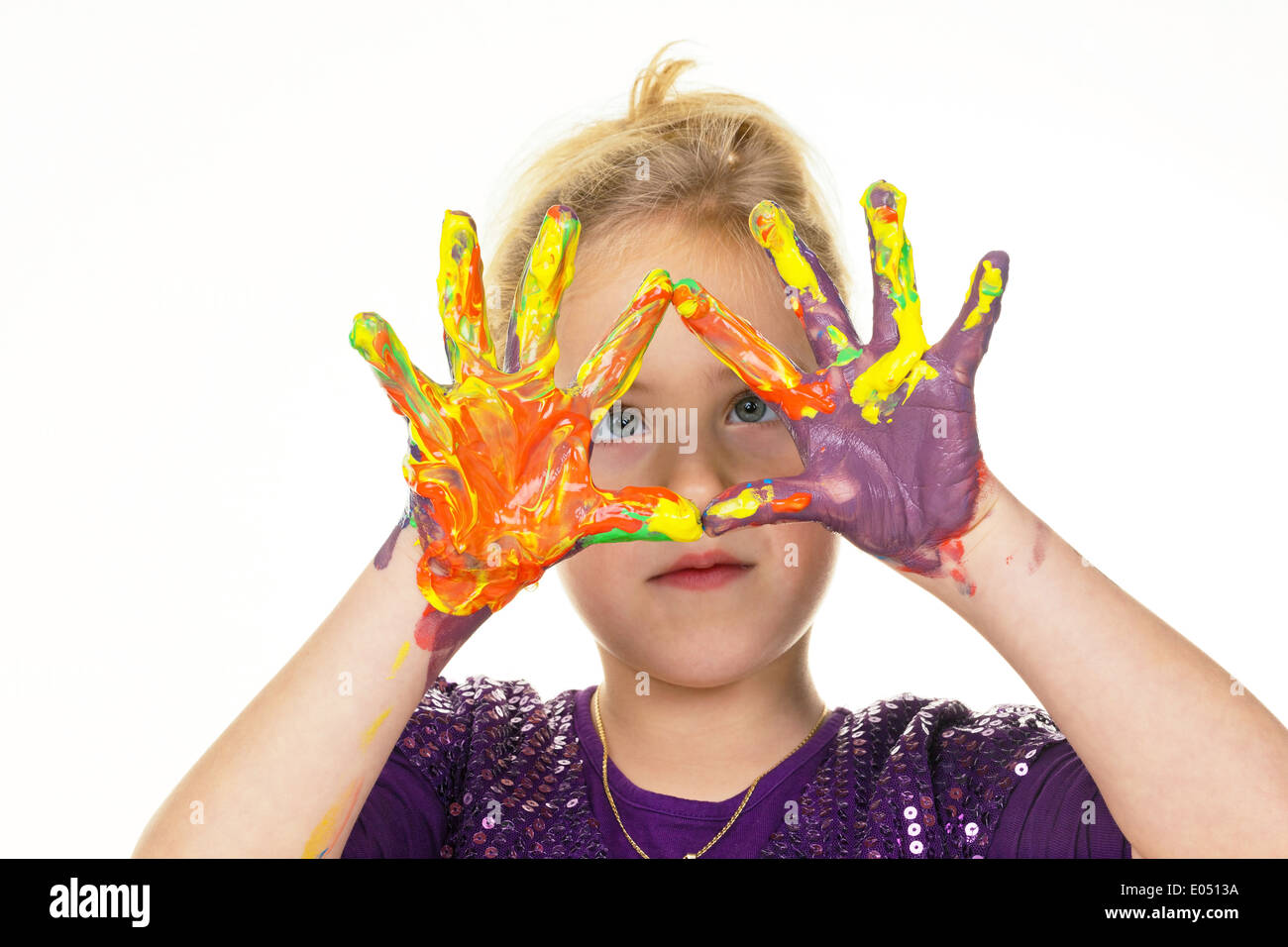 A small child paints with fingerpaints. Funnily and Creatively., Ein kleines Kind malt mit Fingerfarben. Lustig und Kreativ. Stock Photo