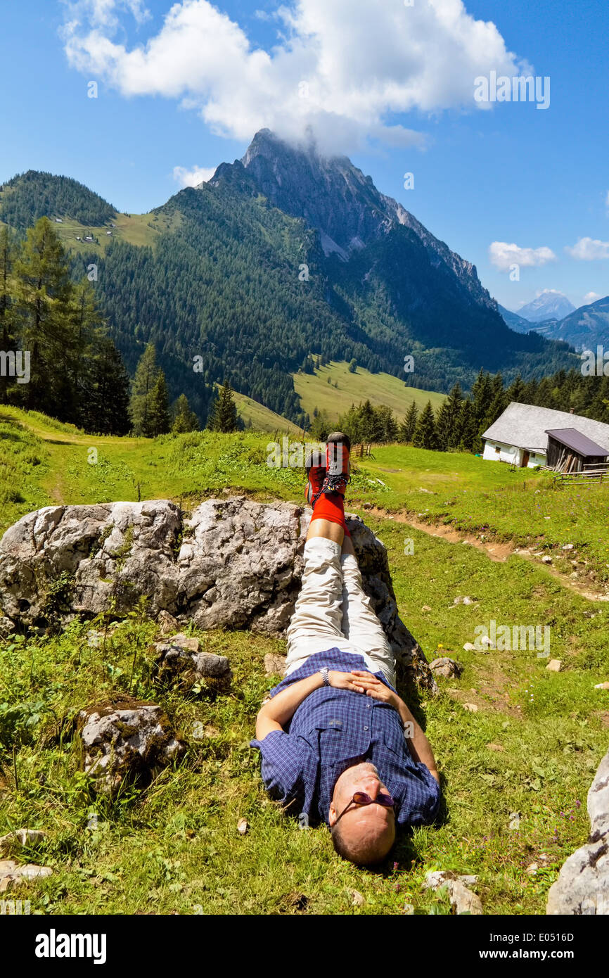 A traveller recovers with a wandering in the mountains from Austria. Activity in the spare time, Ein Wanderer erholt sich bei ei Stock Photo