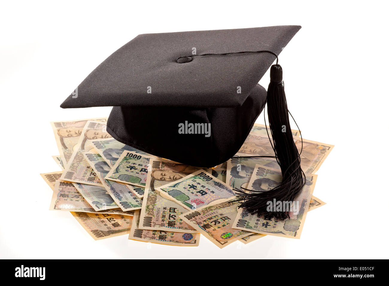 Doctoral cap and yen. Symbolic photo for educational costs in Japan., Doktorhut und Yen. Symbolfoto fuer Bildungskosten in Japan Stock Photo