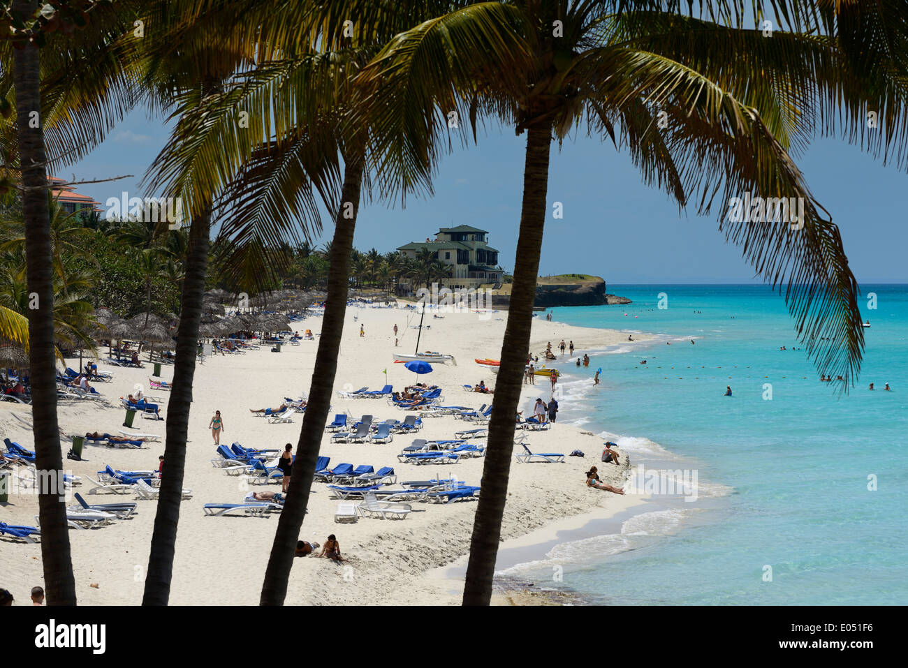 Dupont Xanadu mansion at white sand beach through palm trees at  Varadero resort Cuba and turquoise ocean Stock Photo