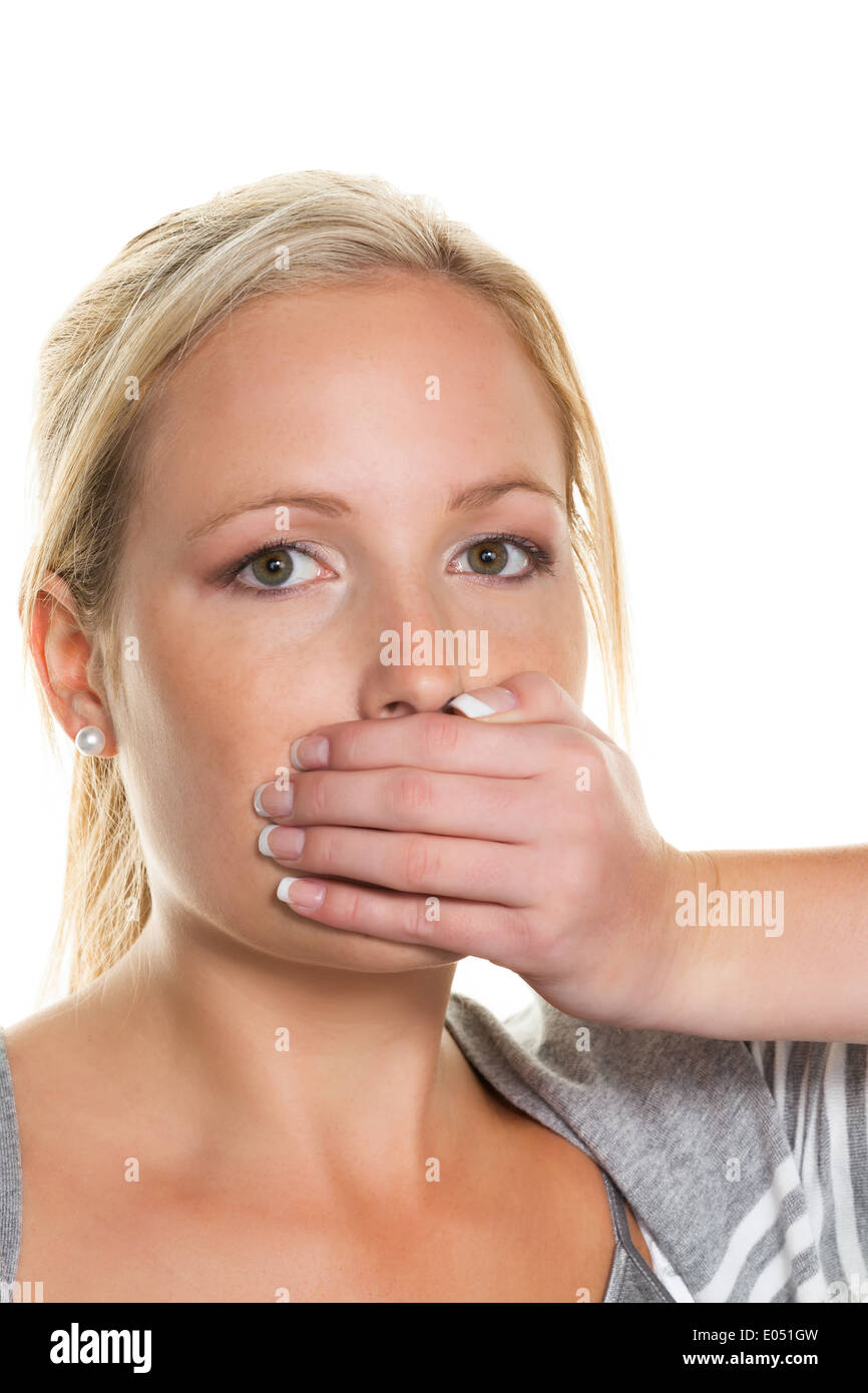 A young woman keeps closed mouth to herself with the hand. Symbolic photo are quiet for, nothing say and refusal of the statemen Stock Photo