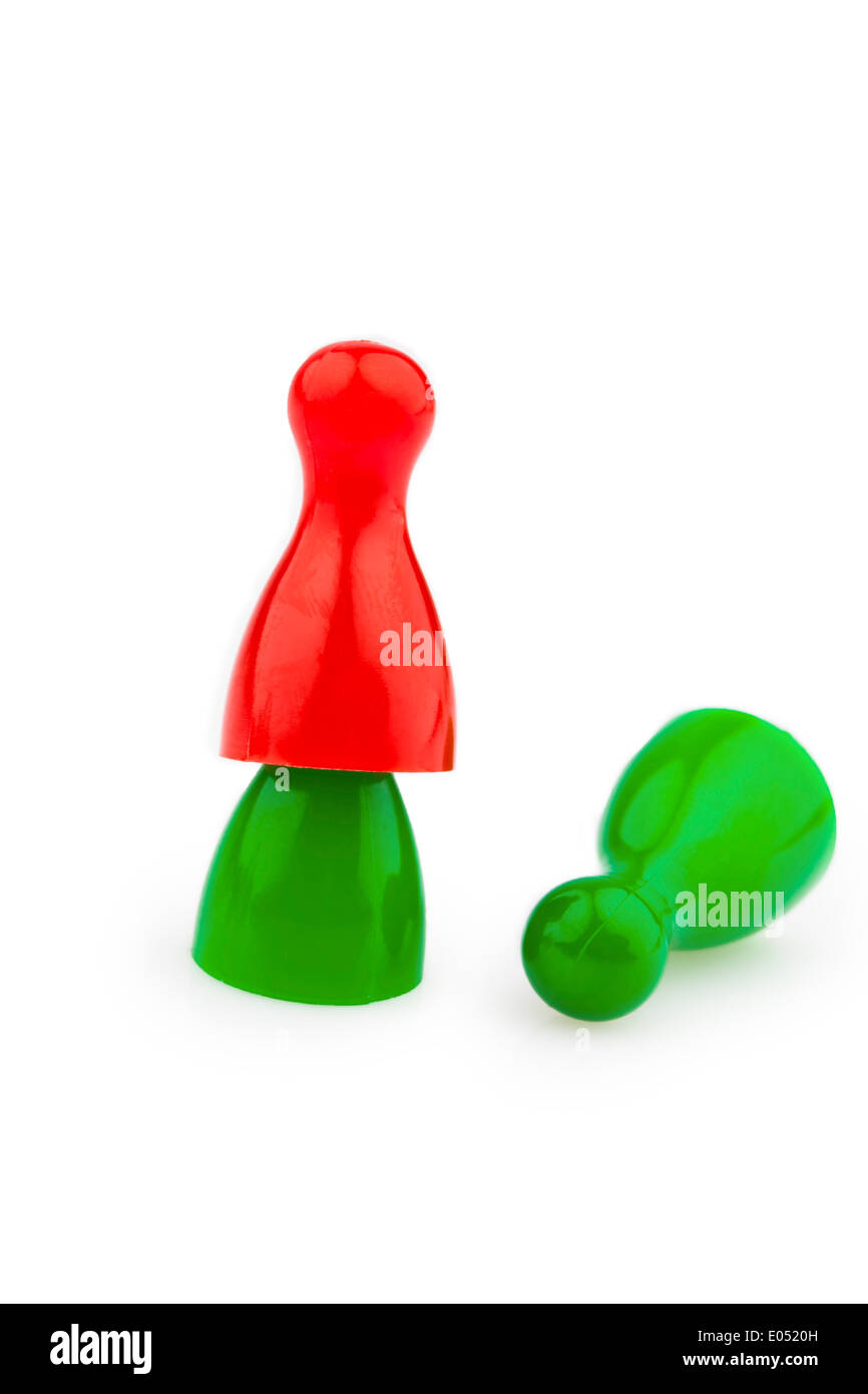 Red and green play figures. Harassment, loneliness and outsider in the team., Rote und gruene Spielfiguren. Mobbing, Einsamkeit Stock Photo
