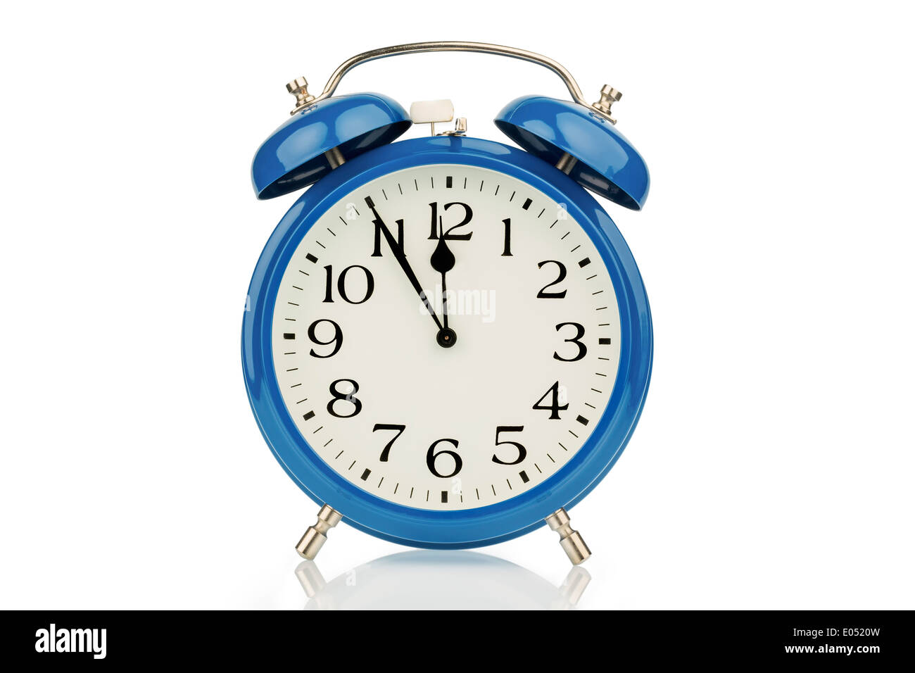 A blue alarm clock on white background. Five before twelve, Ein blauer Wecker auf weissem Hintergrund. Fuenf vor Zwoelf Stock Photo