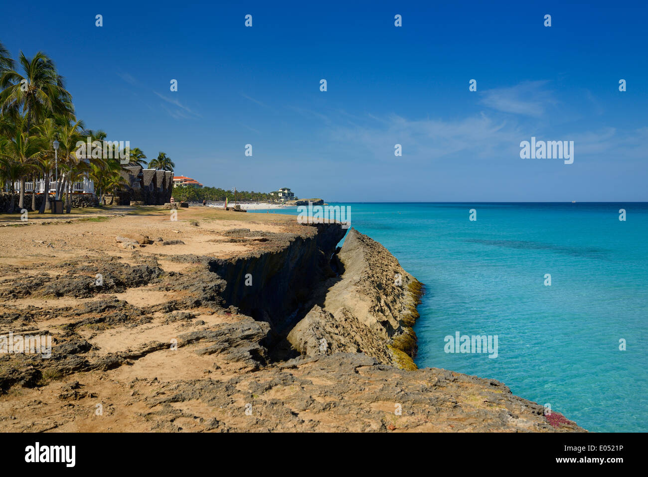 Lava rock shore at Varadero Cuba resort with turquoise ocean  and white sand beach Stock Photo