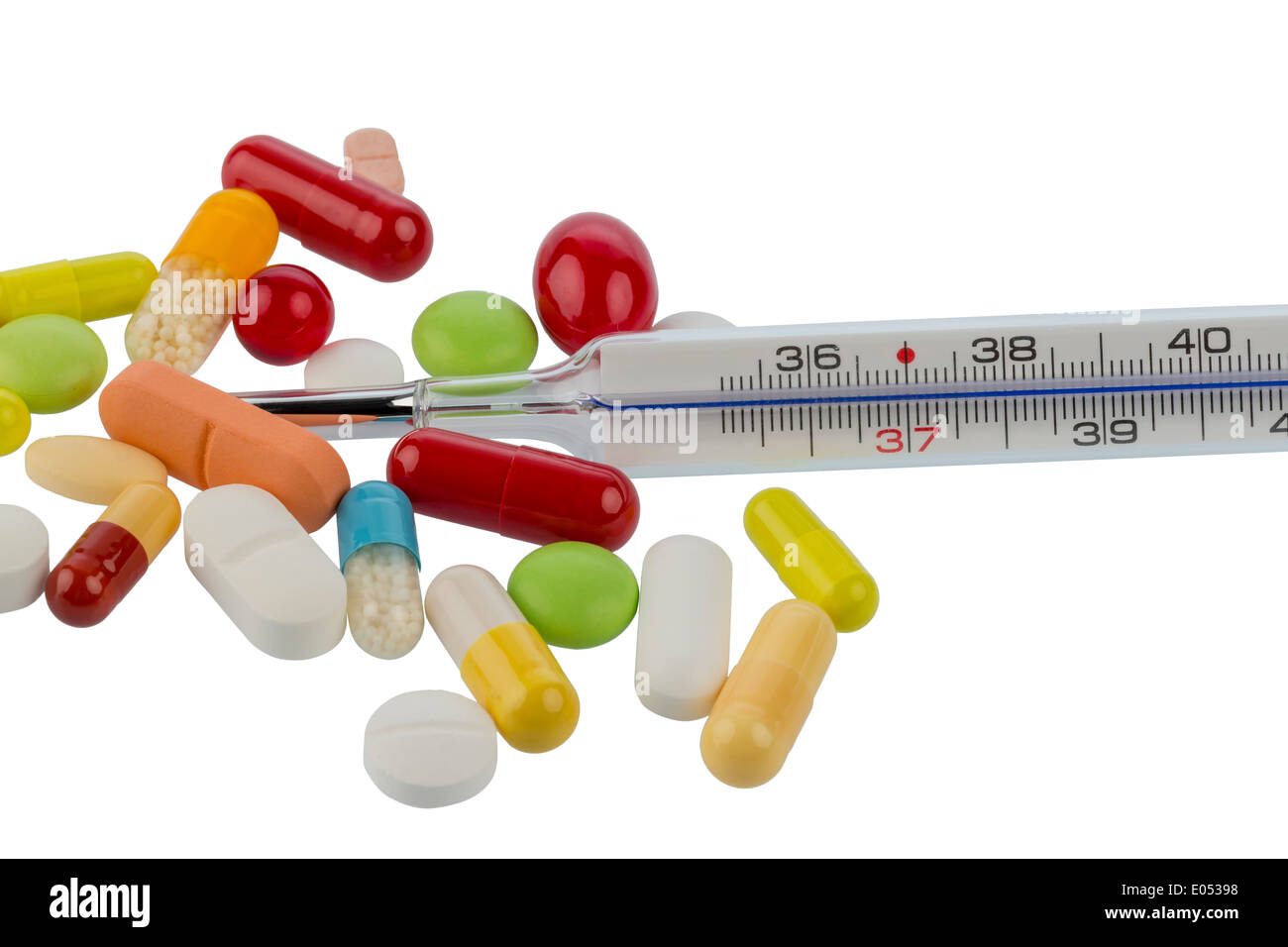 A clinical thermometer and tablets lie on a white background, Ein Fieberthermometer und Tabletten liegen auf einem weissen Hinte Stock Photo
