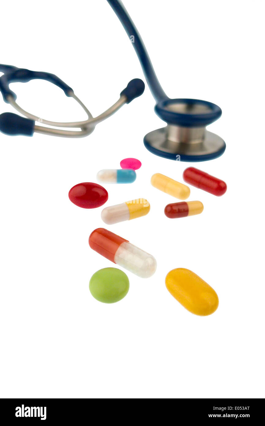 Coloured tablets and a Stethoskop, symbolic photo for diagnostics, heart deseases and interaction, Bunte Tabletten und ein Steth Stock Photo