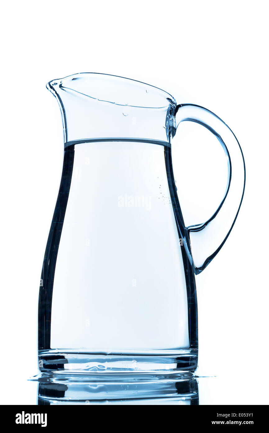 A jug water before white background, symbolic photo for drinking water, water need and consumption, Ein Krug Wasser vor weissem Stock Photo