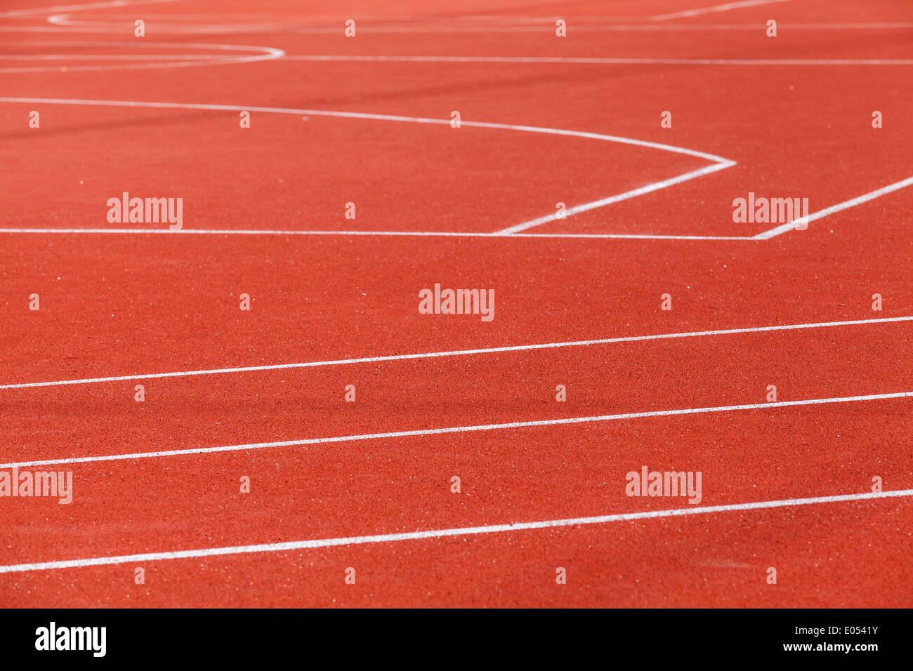Red sports ground with white marking lines Stock Photo