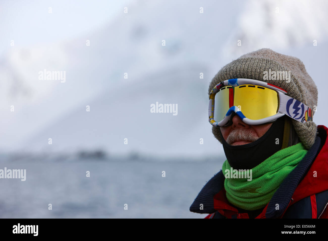 middle aged man wrapped up against the cold on expedition in port lockroy antarctica Stock Photo