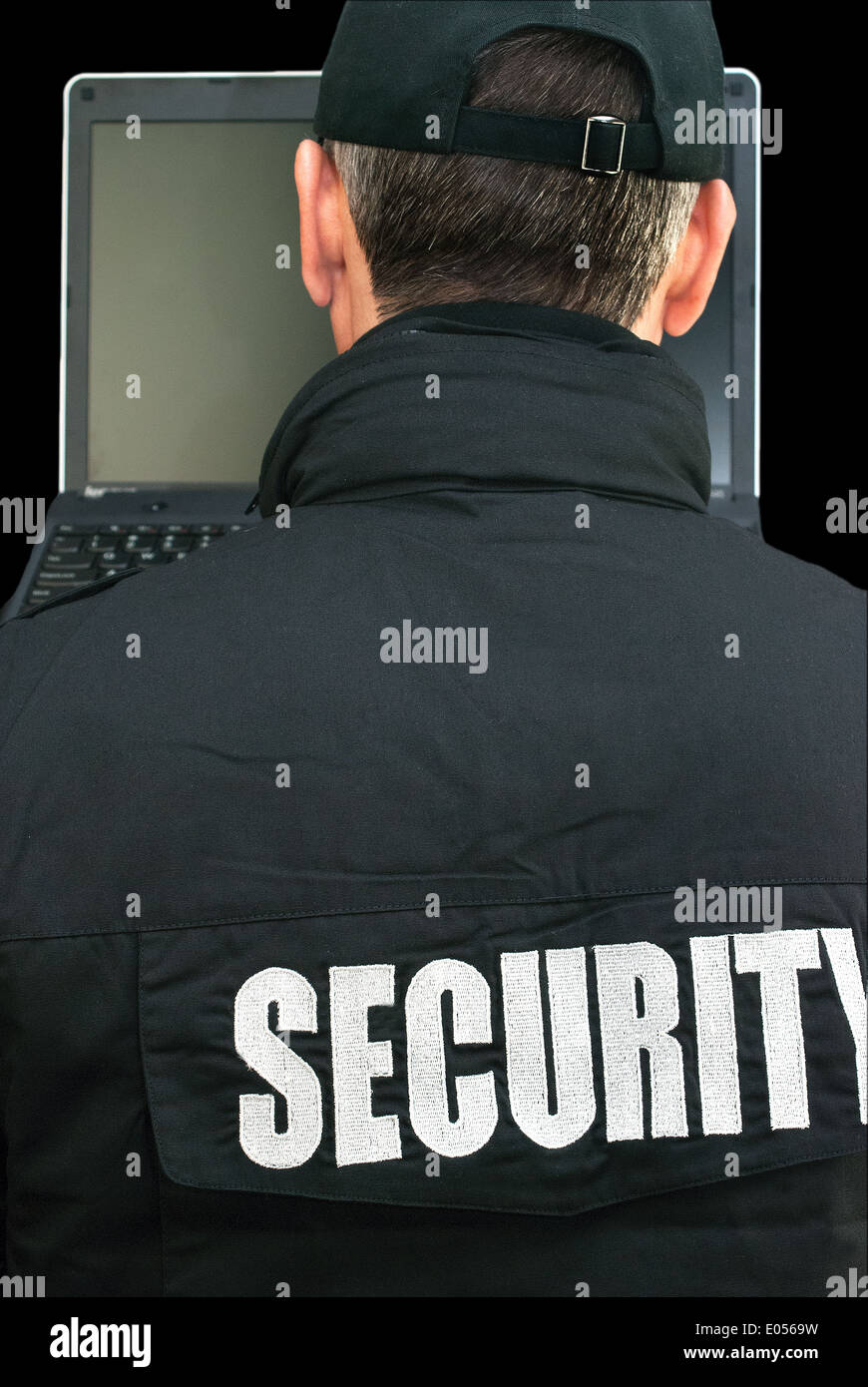 Close-up of security working on a laptop, shot over the shoulder. Stock Photo