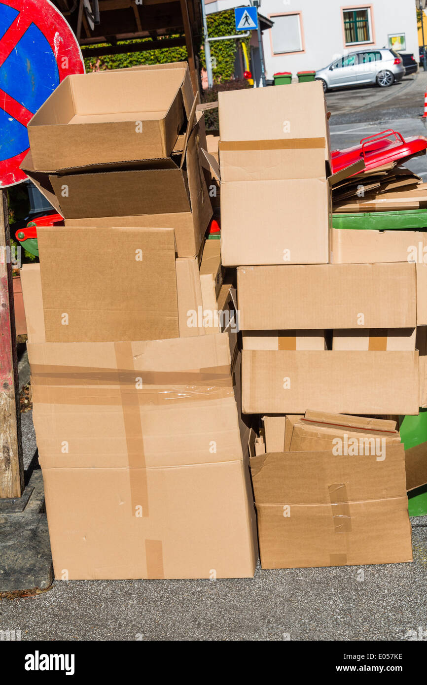 Empty cardboards of packaging wait for the evacuation to the waste paper collective place. Garbage avoidance by okoelogische rec Stock Photo