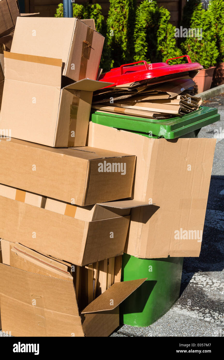 Empty cardboards of packaging wait for the evacuation to the waste paper collective place. Garbage avoidance by okoelogische rec Stock Photo