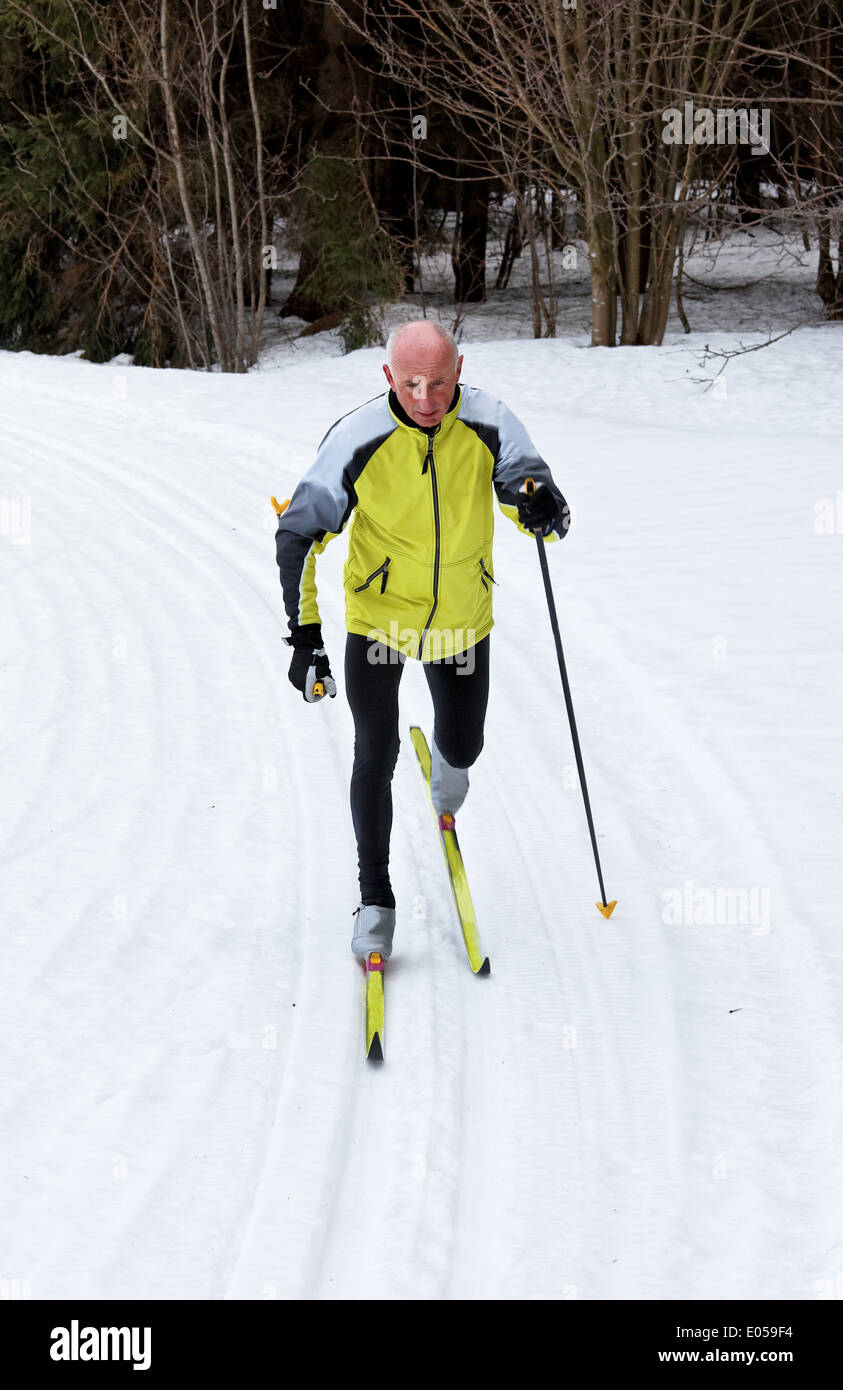 Boss in winter on snow with the cross-country skiing with ski, Senior im Winter auf Schnee beim Langlauf mit Skiern Stock Photo