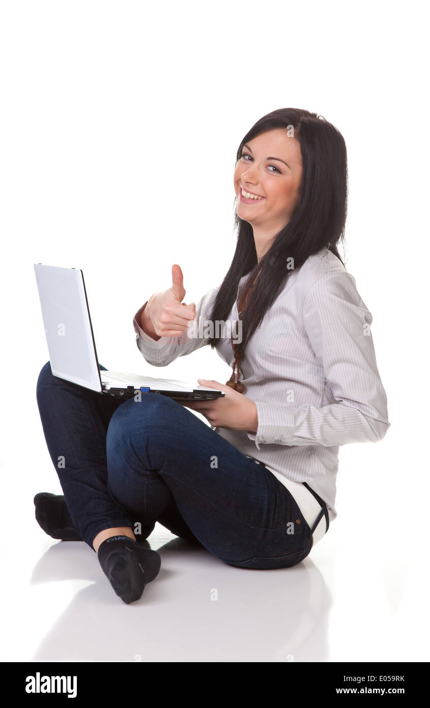 Young girl laughs and works on a laptop, Junges Maedchen lacht und arbeitet an einem Laptop Stock Photo