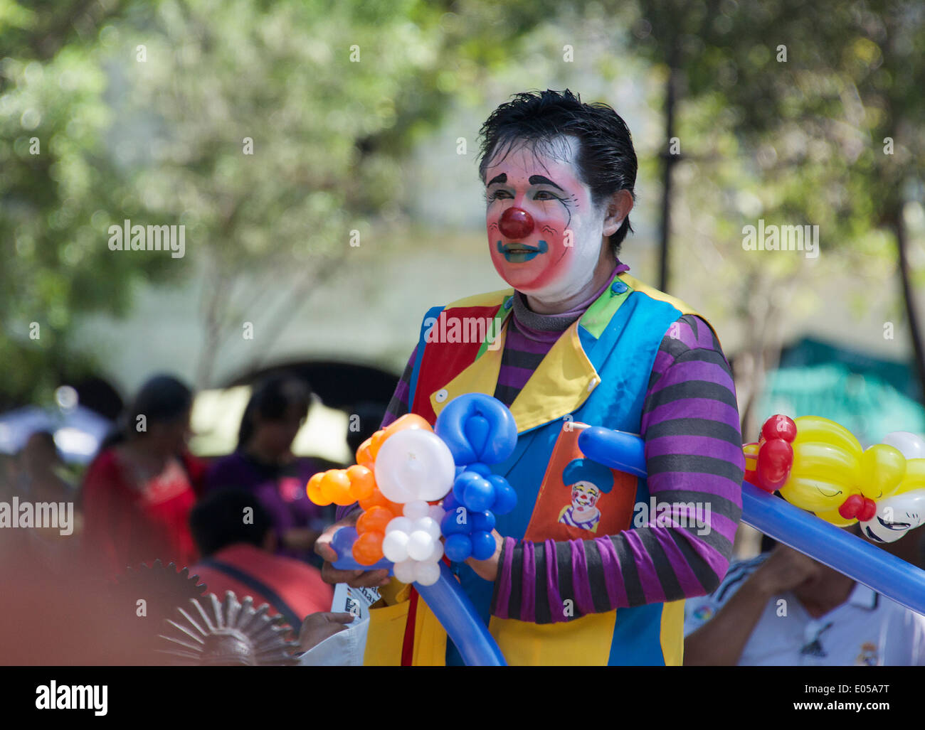 Balloon seller with painted face Zocalo Oaxaca City Mexico Stock Photo