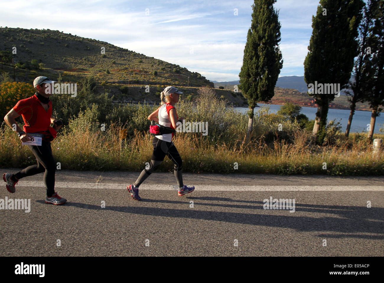 Athens. 2nd May, 2014. Greek female athlete Christina Koureli (R) runs at the 3rd Dolichos Ultra Marathon race in central Greece on May 2, 2014. A total of 26 athletes, among them a Chinese, aim to run nonstop to Sunday afternoon the 255 kilometers course to Olympia, the birthplace of the Olympic Games. © Marios Lolos/Xinhua/Alamy Live News Stock Photo