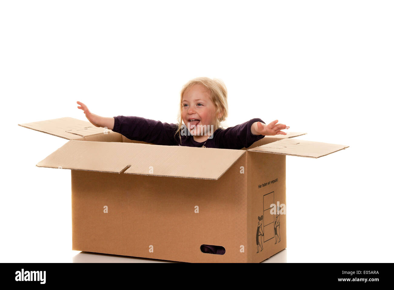 Child in move cardboard. Lies with the move in box., Kind in Umzugskarton. Liegt beim Umzug in Schachtel. Stock Photo