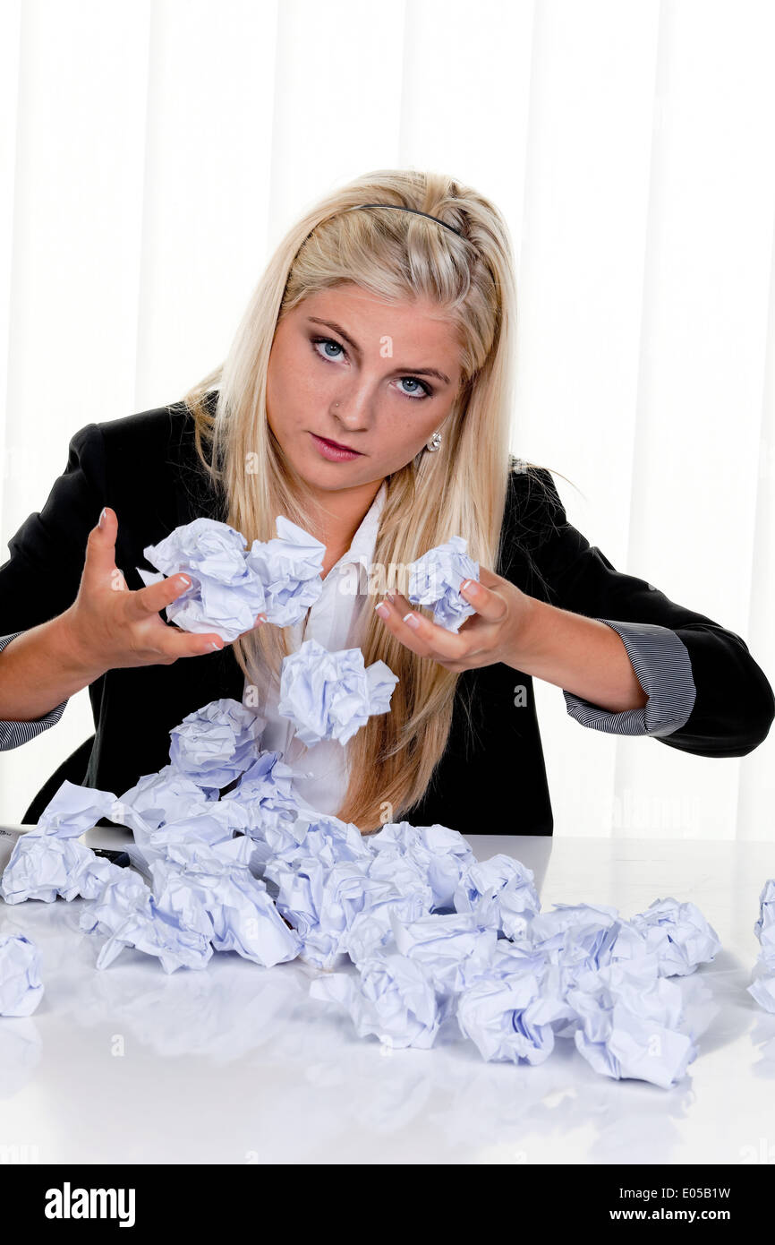 Young woman with paper looks for idea, Junge Frau mit Papier sucht nach Idee Stock Photo