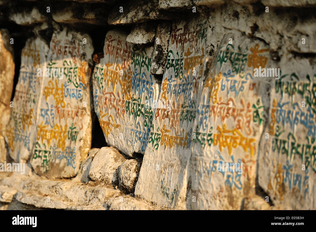 Buddhist mantra written on the surface of a rock, Eastern Bhutan Stock Photo