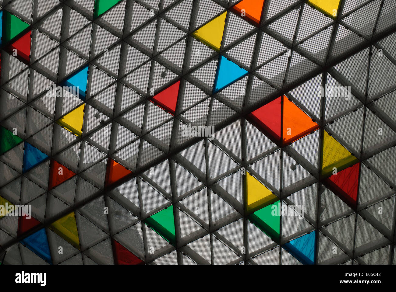 The brightly coloured glass roof tiles of a building in Singapore Stock