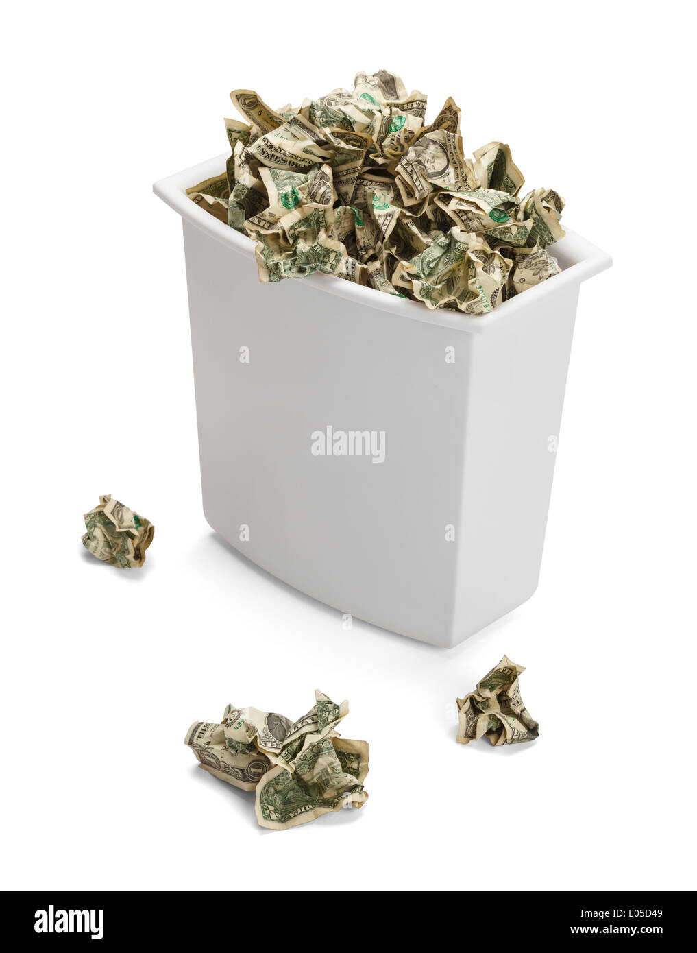 Trash Can full of Crumpled Dollars Over Flowing of Frustration. Isolated on a white background. Stock Photo