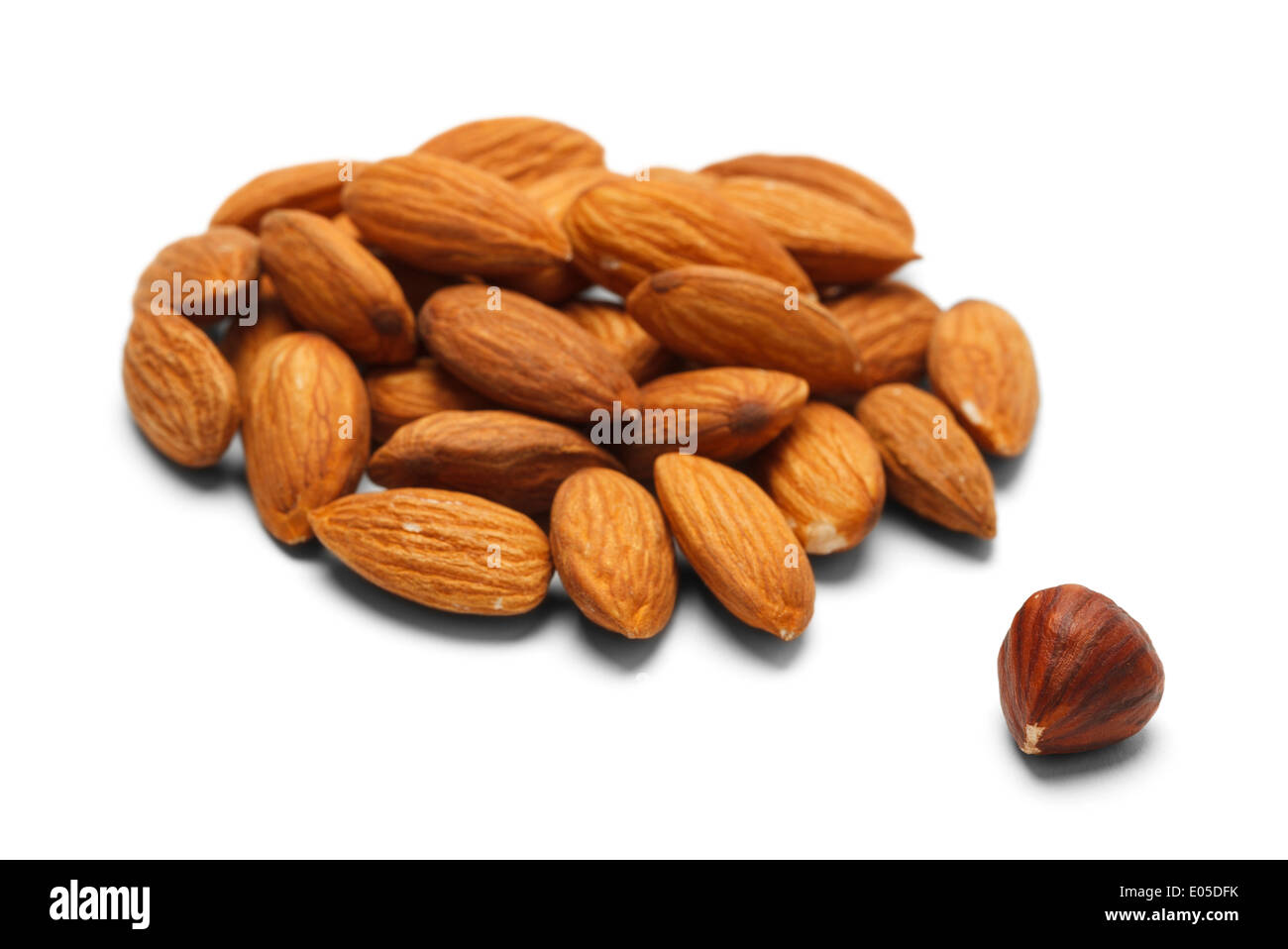 Group of Almonds with a Single Different Nut. Isolated on White Background. Stock Photo
