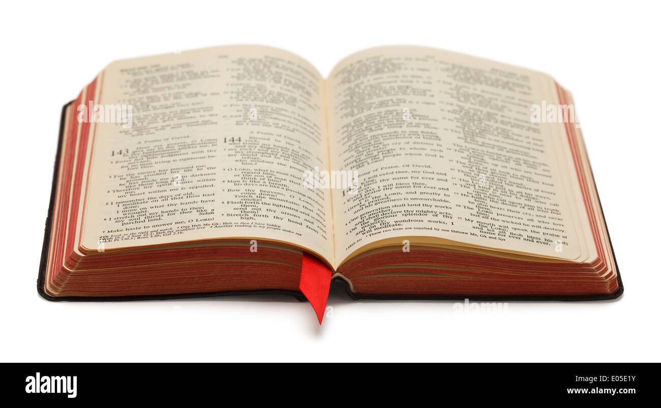 Black Bible With Red Pages Open and Isolated on White Background. Stock Photo