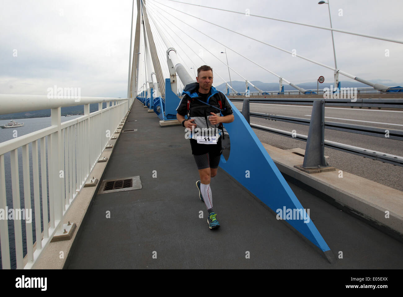 Athens. 3rd May, 2014. A runner crosses the Rio-Antirrio Bridge which connects mainland Greece to the Peloponnese peninsula during the 3rd Dolichos Ultra Marathon on May 3, 2014. A total of 26 athletes, among them one Chinese, started on Friday running nonstop a 255 kilometers race with a 48 hours time limit to Olympia, the birthplace of the Olympic Games. © Marios Lolos/Xinhua/Alamy Live News Stock Photo