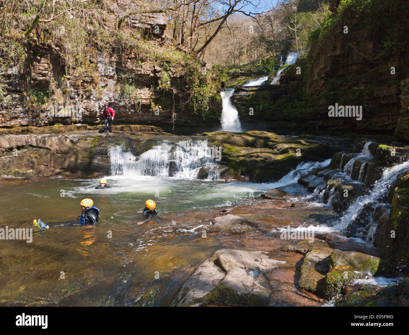 Canyoners in Sgwd Isaf Clun-gwyn falls on the Afon Mellte, in Brecon Beacons National Park waterfalls country Stock Photo