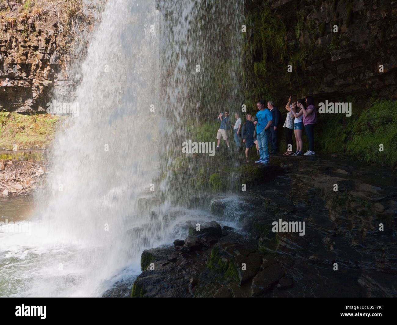 Standing behind the famous Sgwd yr Eira waterfall in the Brecon Beacons ...