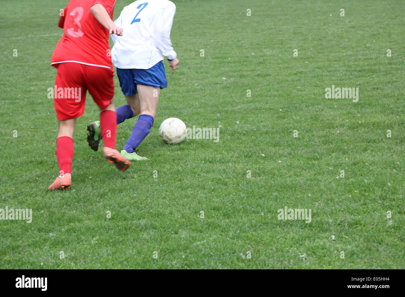 Soccer or football players in action on the field Stock Photo