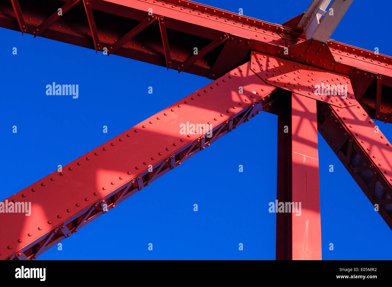 Red bridge girders under a deep blue sky Stock Photo Alamy