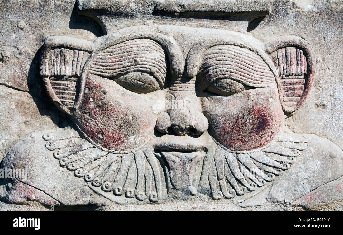 Egypt,Dendera,Ptolemaic temple of a goddess Hathor.A colossal head of the god Bes in the courtyard Stock Photo