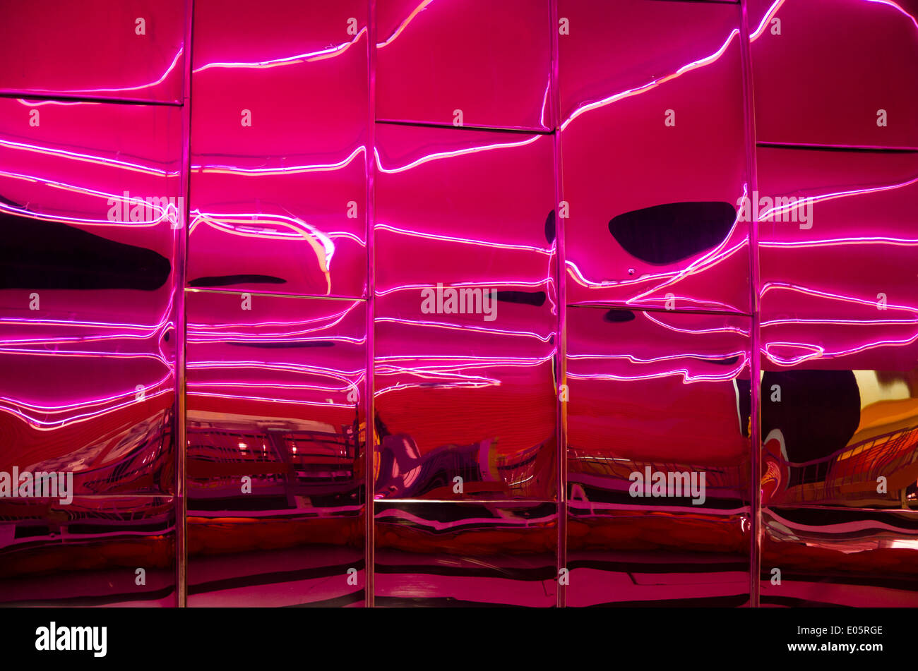Pink neon lights reflected in stainless steel architecture. Taken at The Public arts Centre, West Bromwich West Midlands UK. Stock Photo