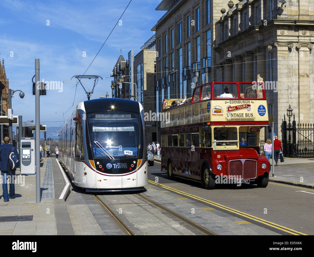 Edinburgh tram and a vintage open topped tourist bus by the St Andrew Square stop Stock Photo