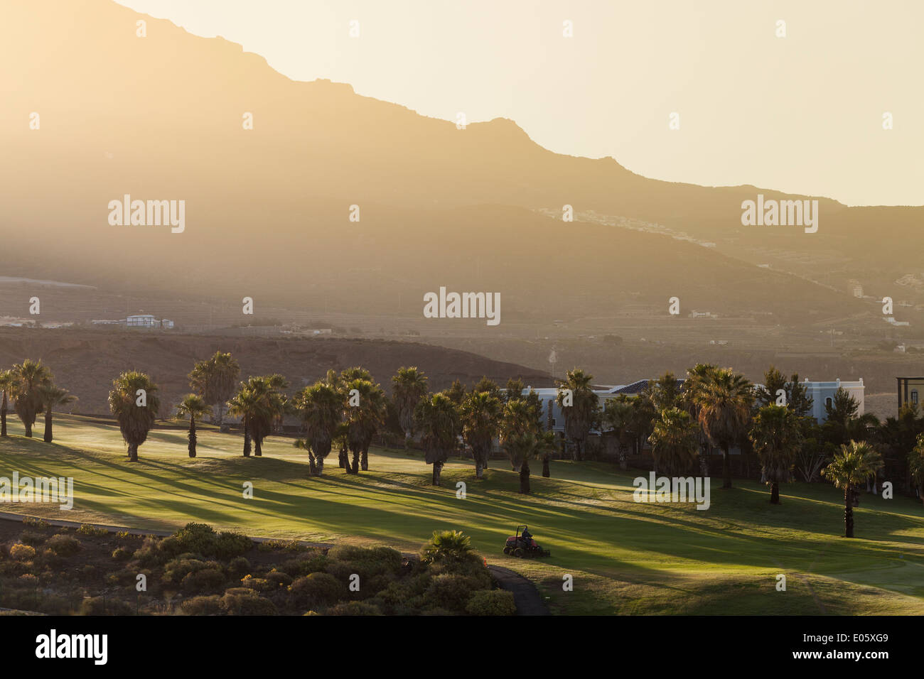 Dawn light breaking over the ridge onto Adeje golf course, Tenerife, Canary Islands, Spain. Stock Photo