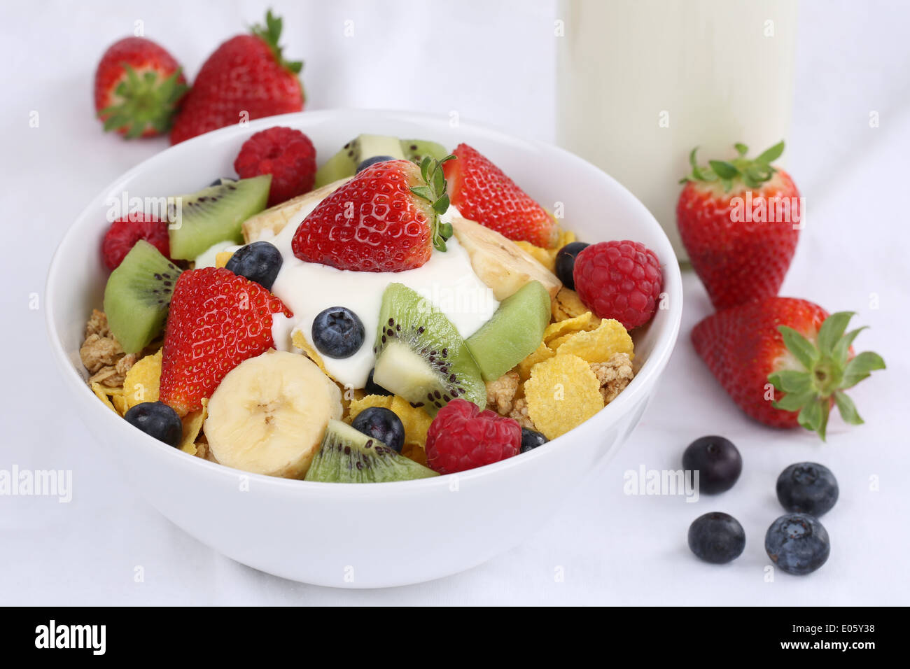 Fruit muesli with yogurt, strawberries, banana, raspberries, kiwi and blueberries for breakfast Stock Photo