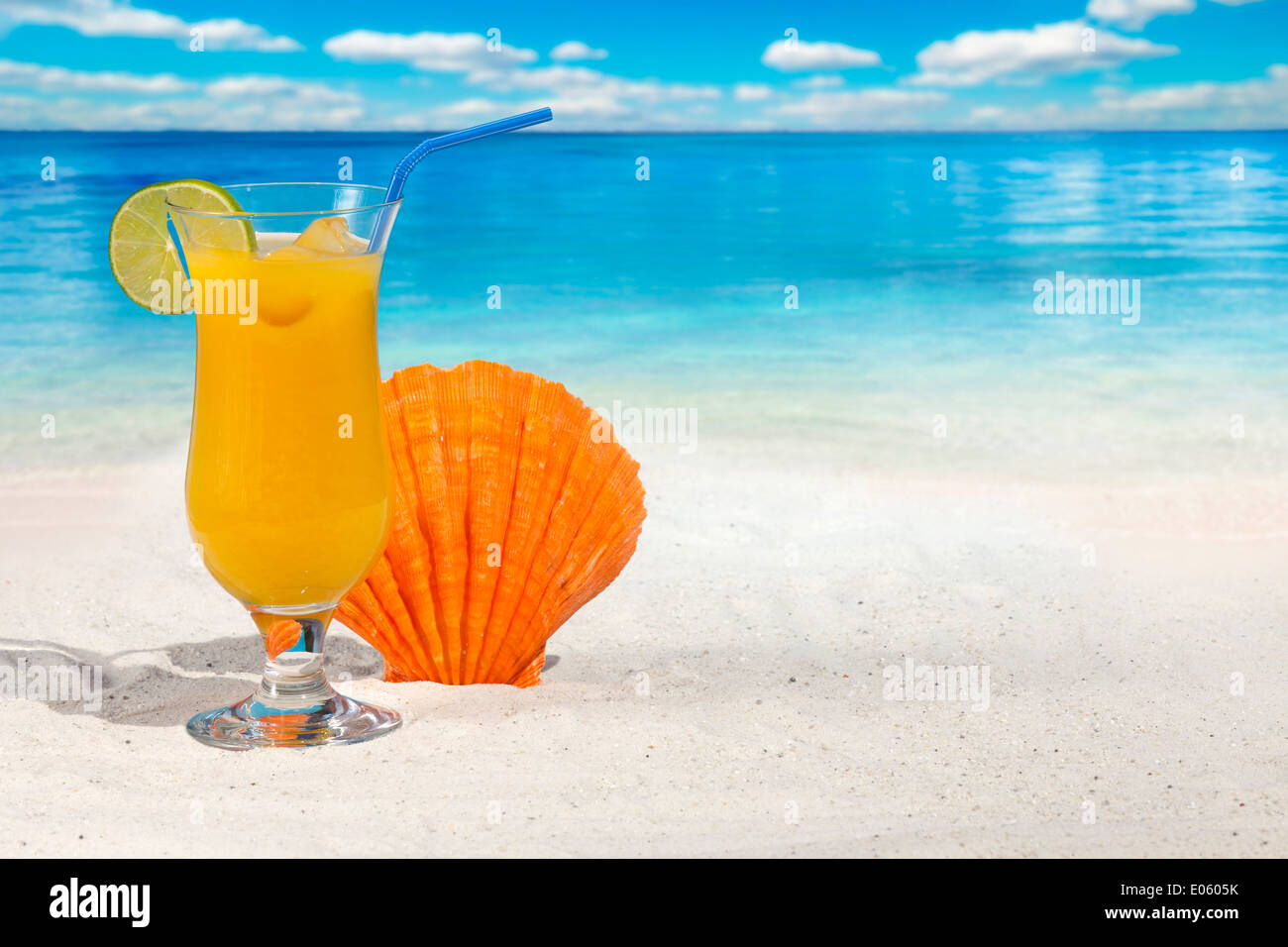 Fruit Cocktail with Orange and Drinking Straw on the Beach with Scallop ...