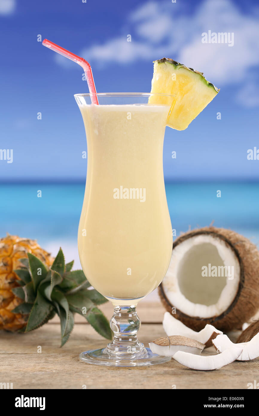 Cold Pina Colada cocktail with fruits on the beach while on vacation Stock Photo