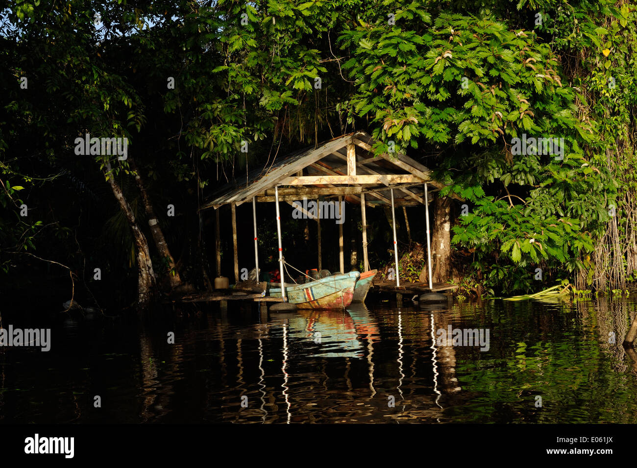 A boathouse with boats on the edge of a canal near Tortuguero, Tortuguero National Park, Limon Province, Costa Rica. Stock Photo
