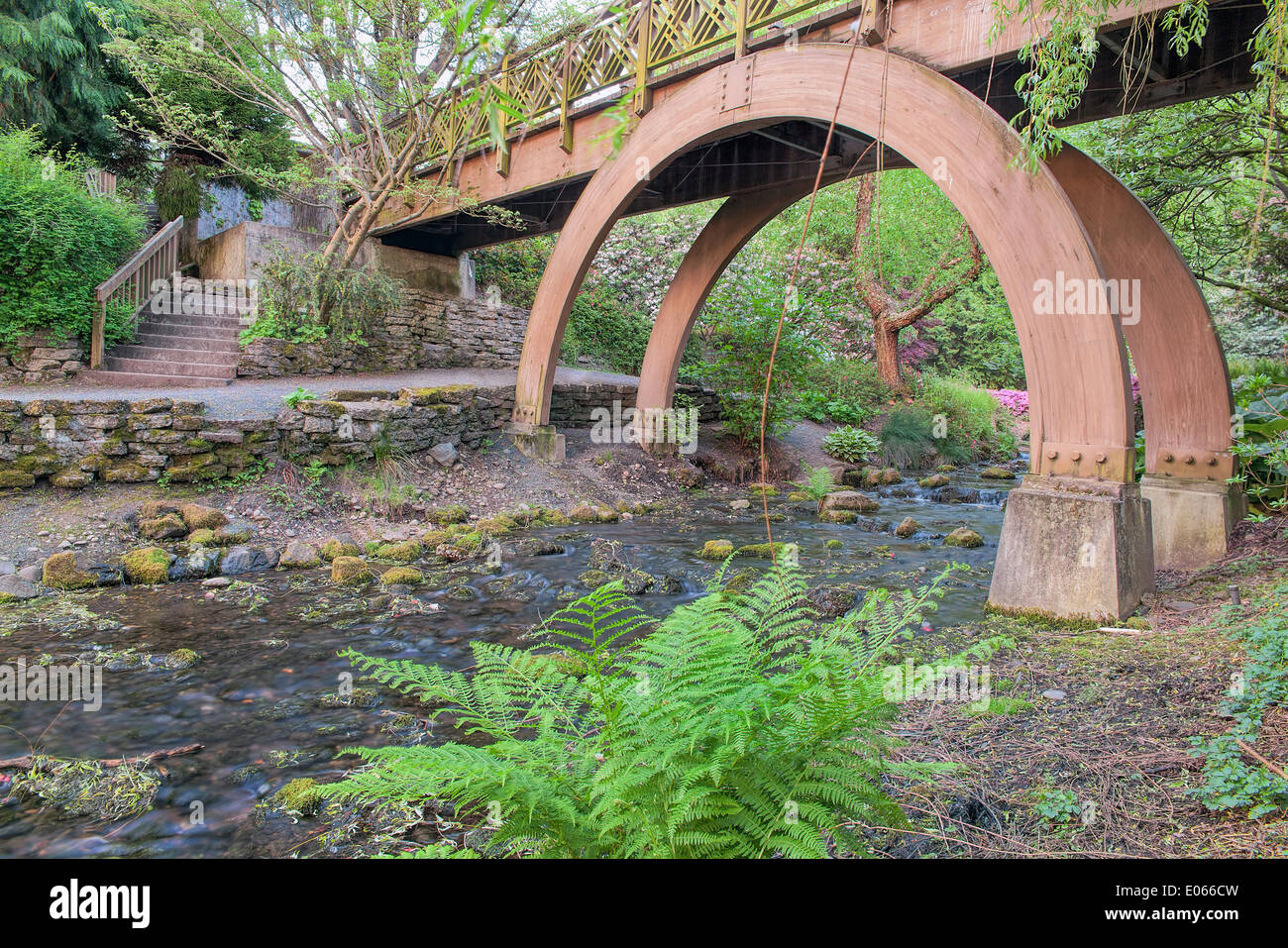 Wooden Foot Bridge Over Water Creek at Crystal Springs Garden in Springtime Stock Photo