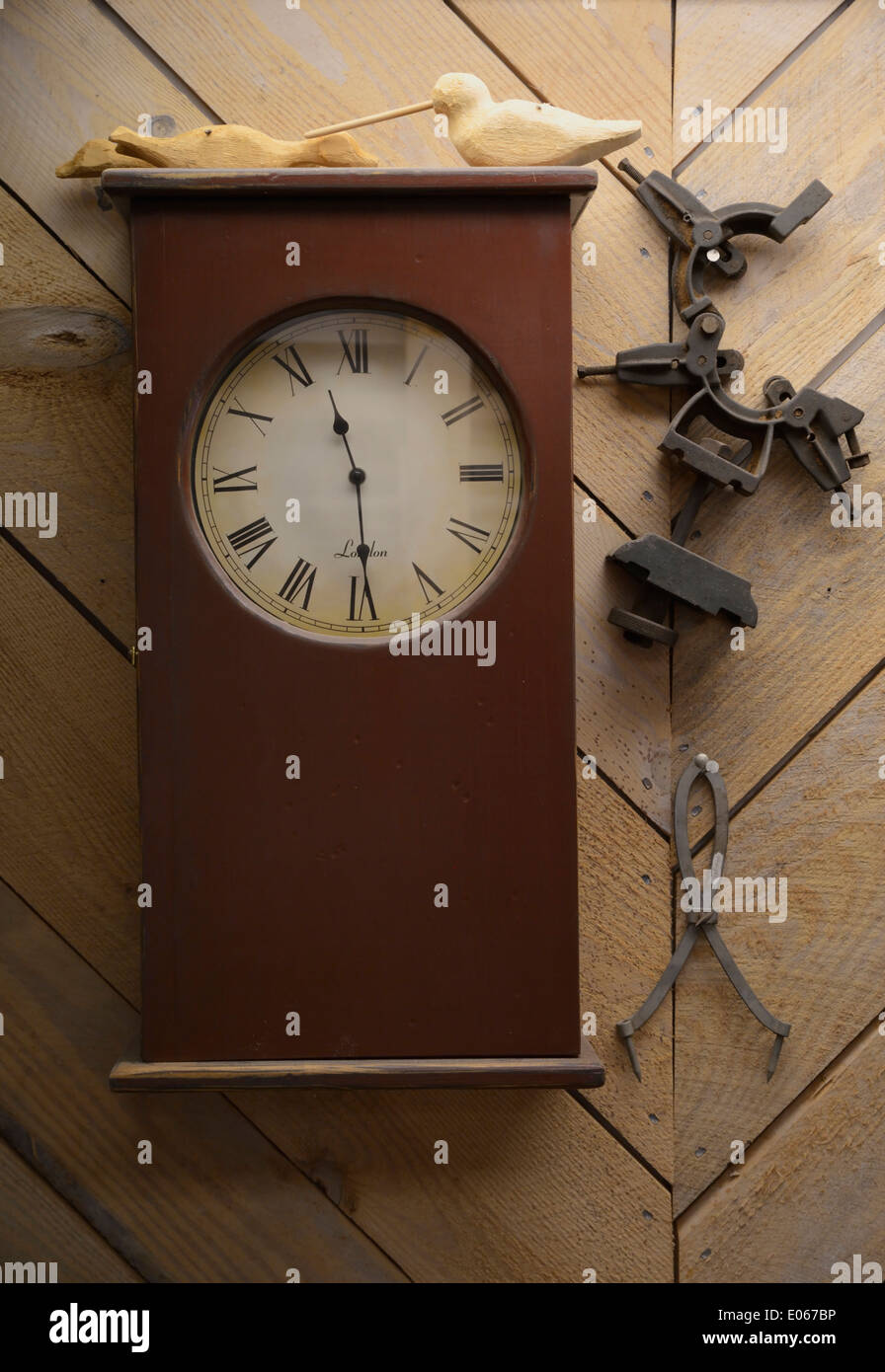 Wood cased clock with Roman numerals, on wall Stock Photo Alamy