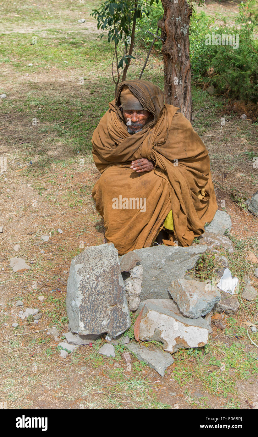 Homeless Man sitting in front of St. Raquel and Elias Church Museum in Addis Ababa, Ethiopia Stock Photo
