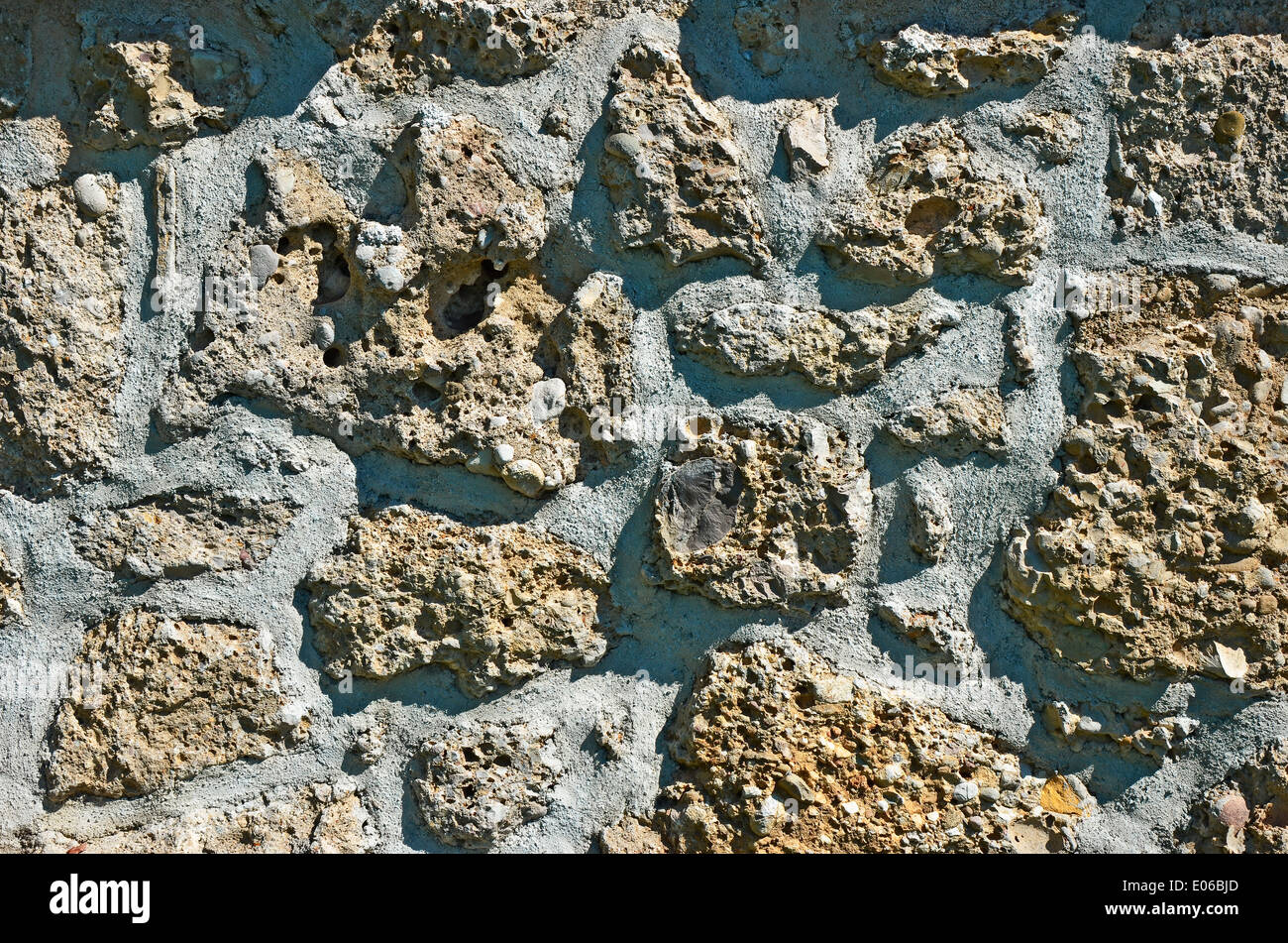 Masonry - Old stone wall structure from individual units laid in and bound together by mortar. Stock Photo
